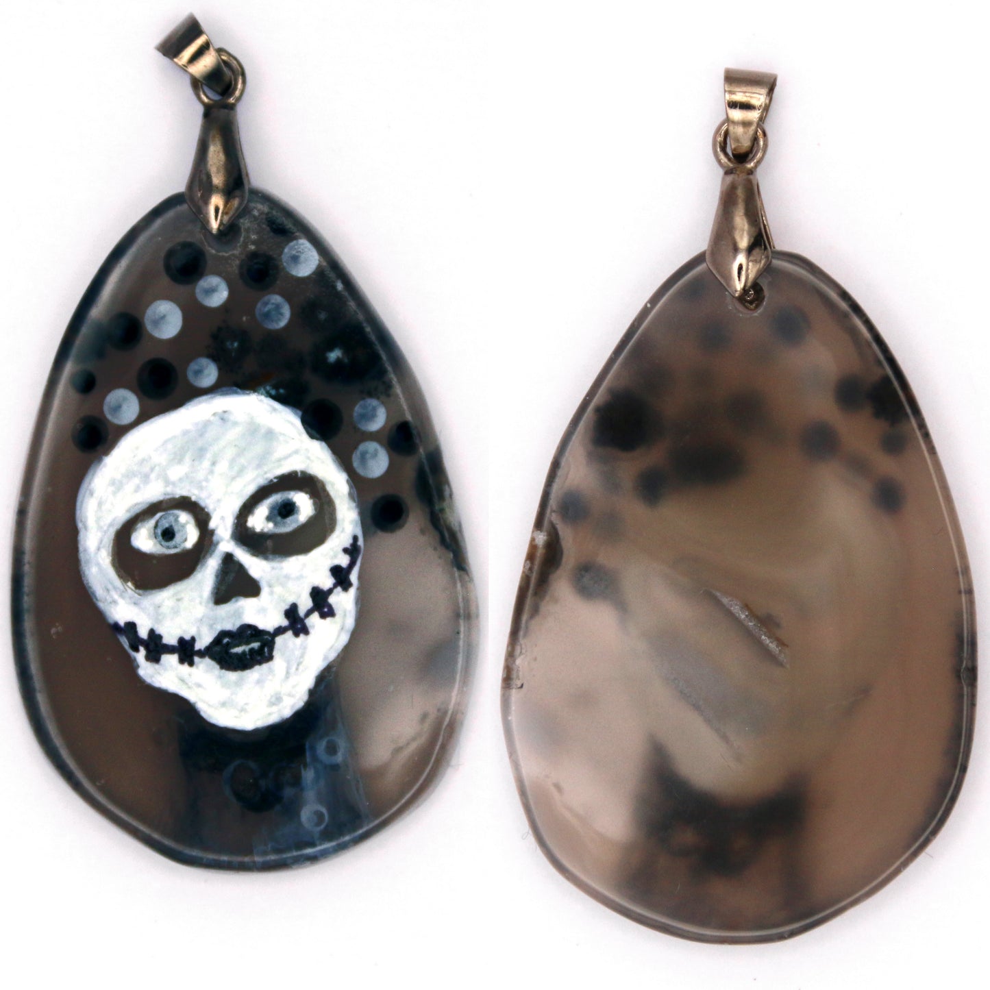 The front and back of the pendant. The back is a slightly translucent brownish gray. The woman's hair and throat show through the most from the front, but you can definitely see the outline of her head too.