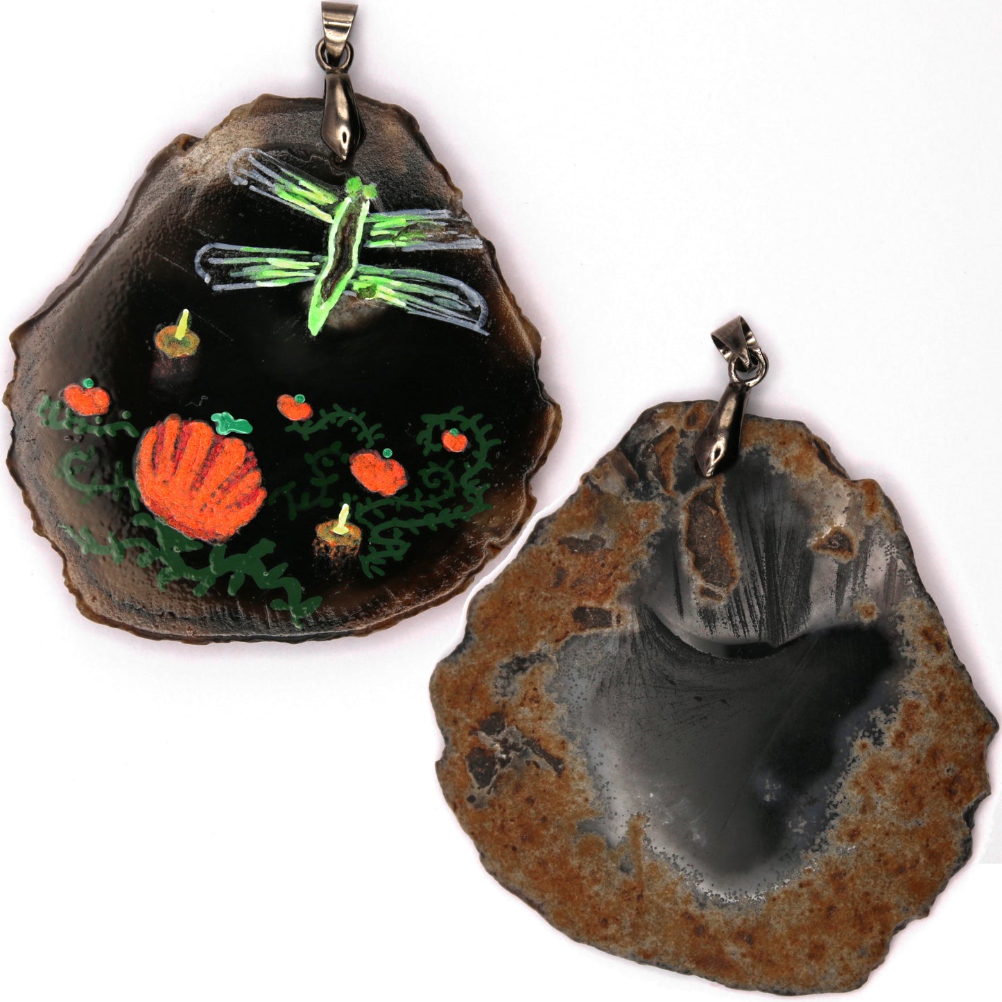 The front and back of the pendant. The back differs from the front in that is has a lot of rusty colored rock and only the center is smooth grey. There are also some smoothed tool marks near the top.