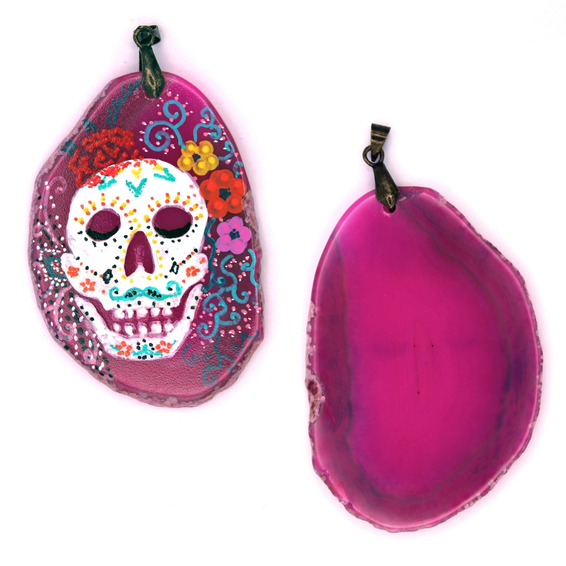 The front and back of the pendant. The back is mostly opaque hot pink. You can slightly see the black from the bottom of the eyes on the front. There are also dark rings near the edges of the back.