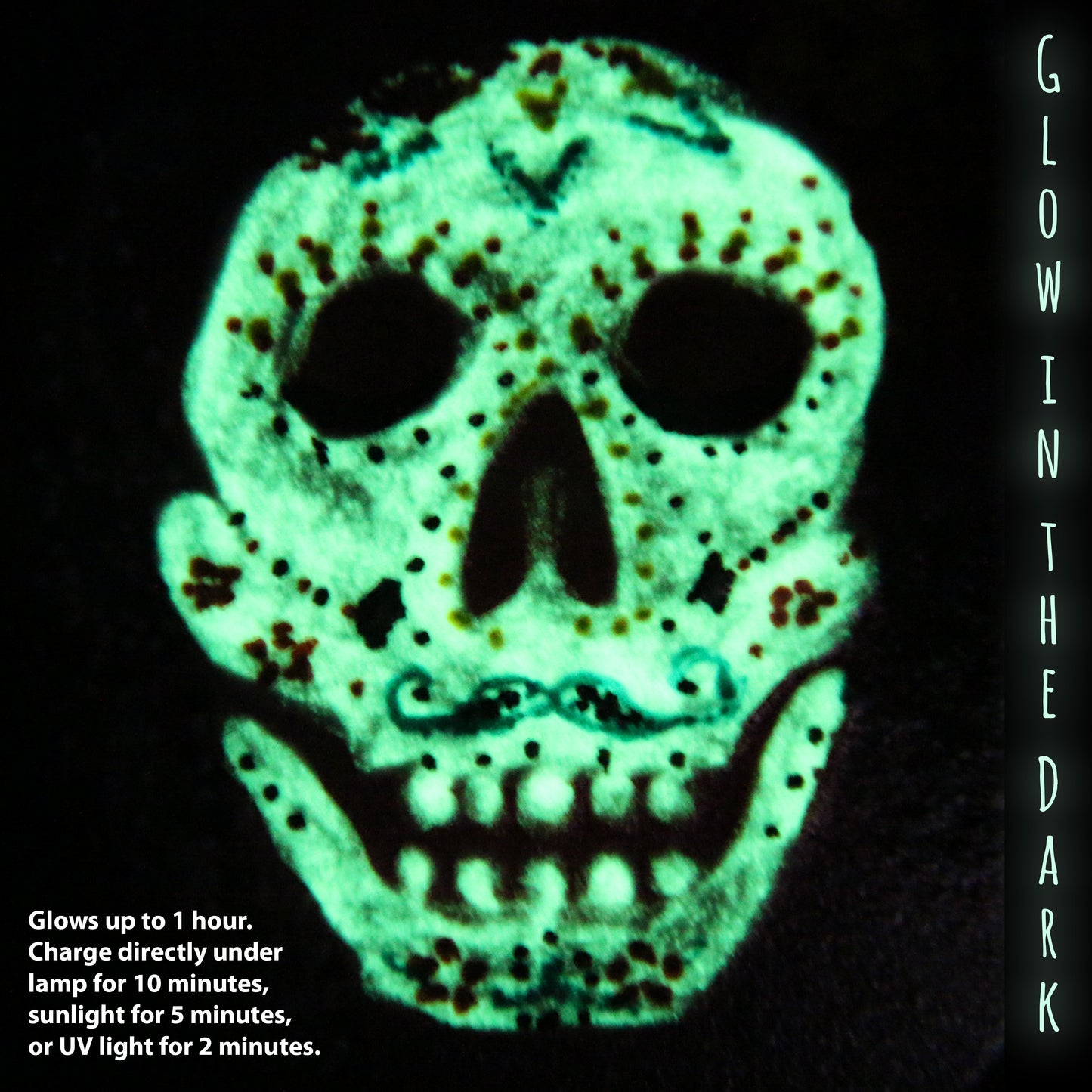 A detailed  Glow-In-The-Dark Sugar Skull. Green glow with lots of dark unlit details.
Glows up to 1 hour. Charge directly under: a lamp for 10 minutes, sunlight for 5 minutes, or UV light for 2 minutes.